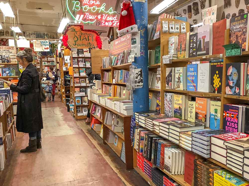 Green Apple Bookstore in San Francisco. Woman in bookshelf