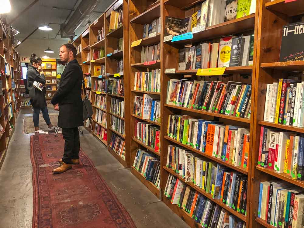 Browser Books in SF. Man browsing bookshelves