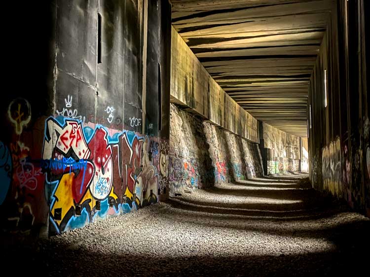 Donner train tunnels #7 with graffiti and light shafts