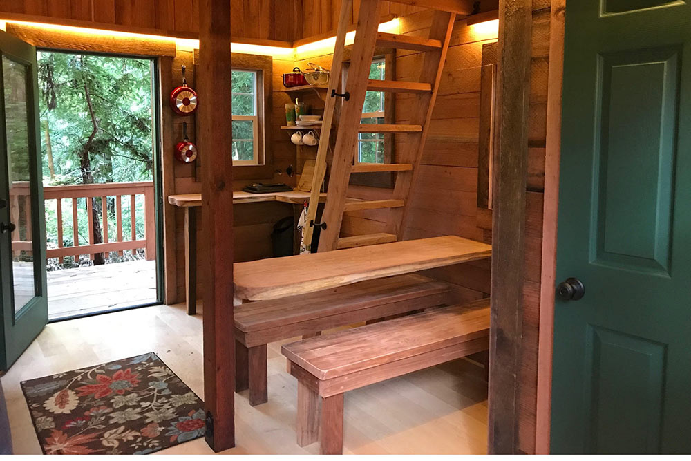 Santa Cruz tree house Juju cabin. wood interior with benches