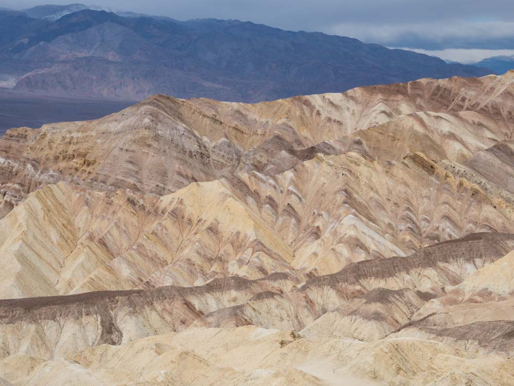 Gower Gulch loop trail death valley. Beige rock landscape and mountains