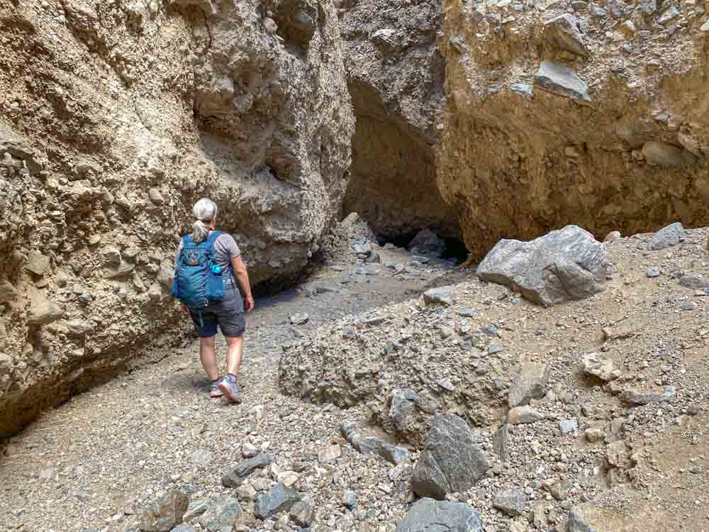 Sidewinder Canyon hike - #1 slot canyon. woman hiking into a narrow slot