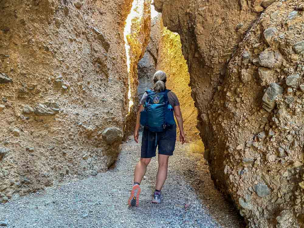 Sidewinder Canyon California - #3 slot canyon. woman with backpack in narrow canyon