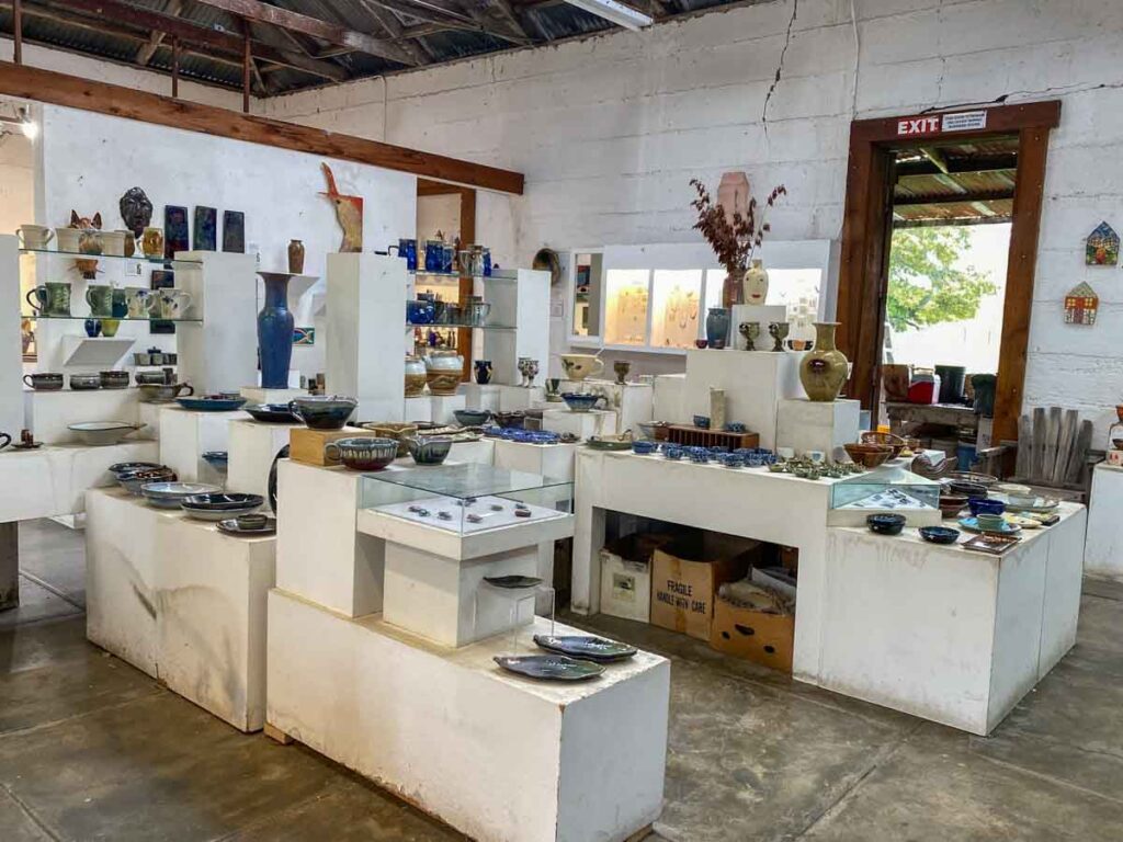 Harmony Pottery Studio- white room with shelves of pottery and ceramics