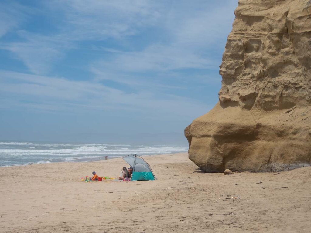 Pomponio Beach in Half Moon Bay. shade tent and family on beach