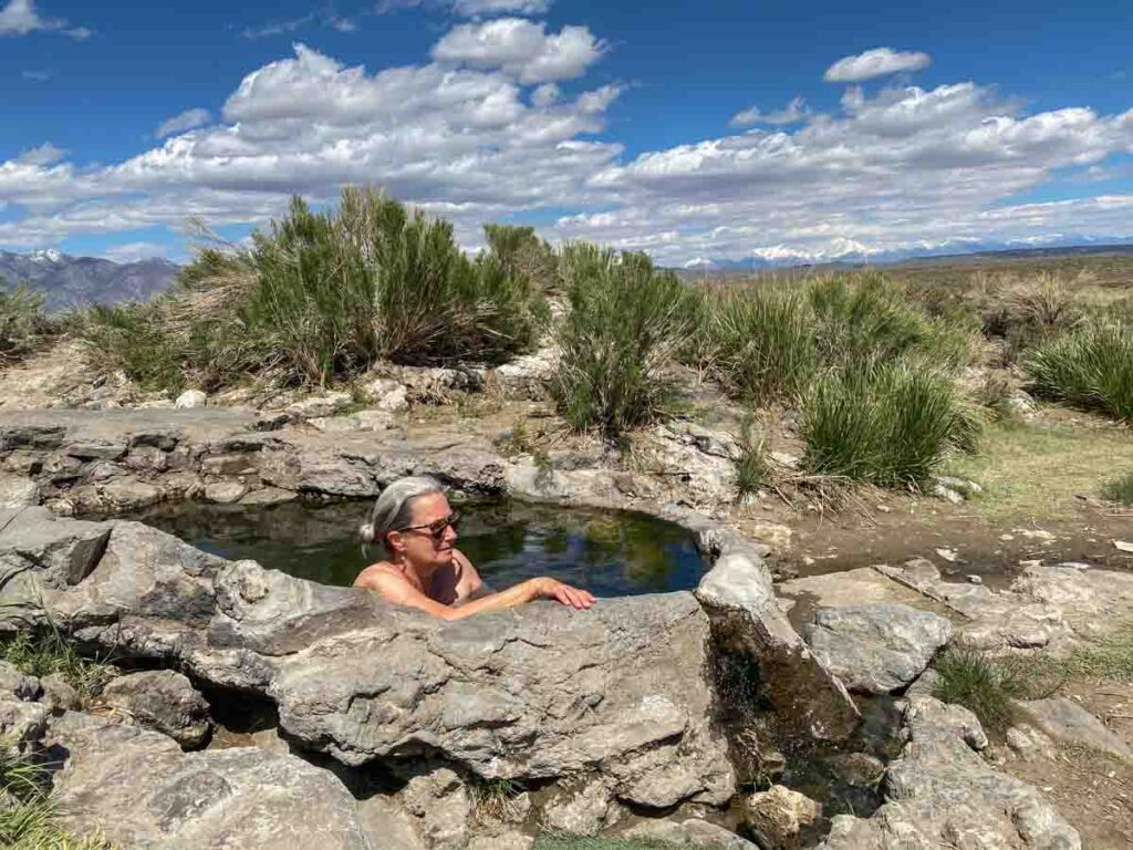 Rock Tub hot springs near Mammoth CA. woman in natural hot tub pool