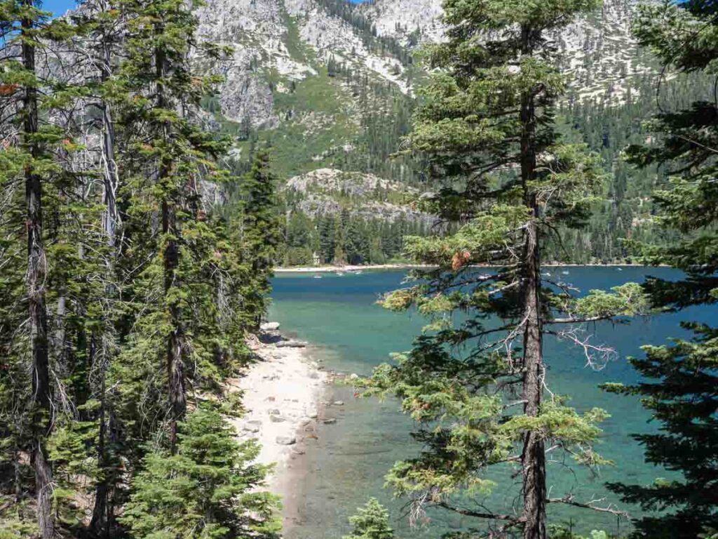 Rubicon trail view of Lake Tahoe Emerald Bay. Lake beach and pine trees