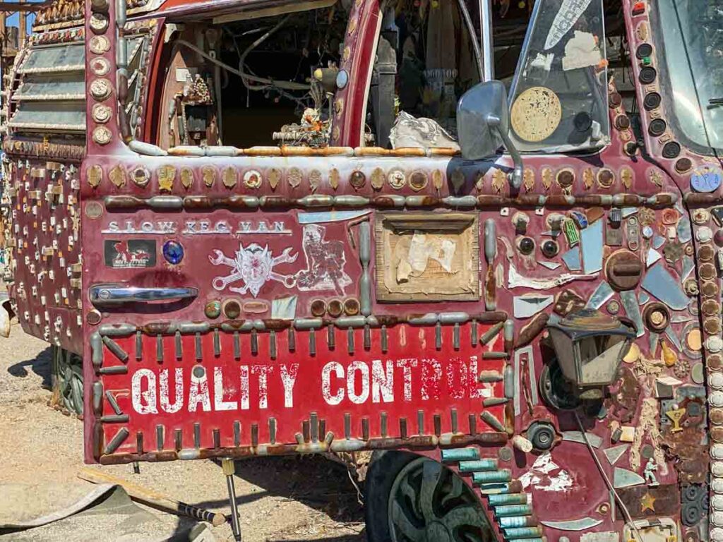 Decorated car with quality control sign in East Jesus