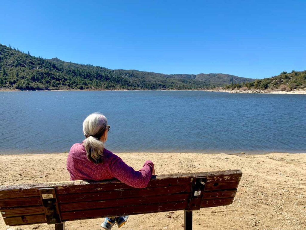 Lake Hemet Highway 74. woman on a bench overlooking a lake