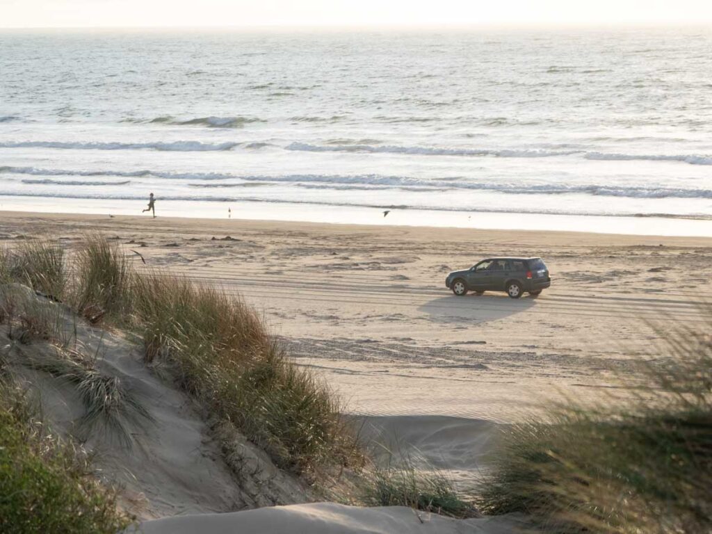 Pismo State Beach car and runner with dune