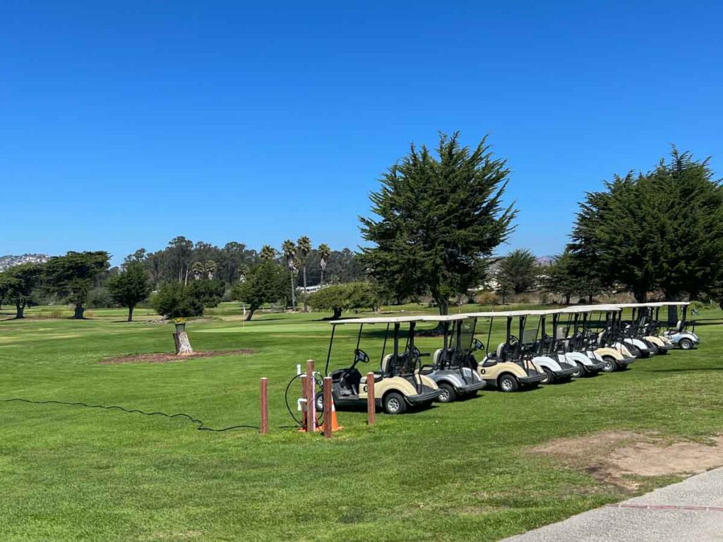 Pismo beach golf course with grass and golf carts. 