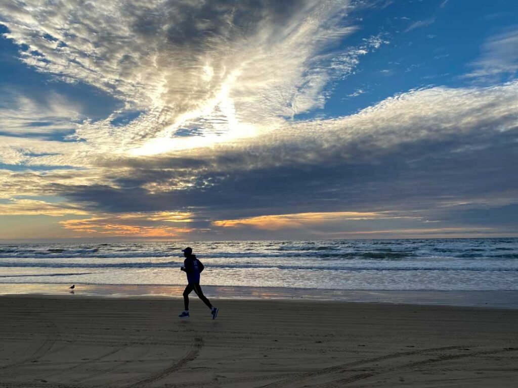 Pismo State beach at sunset with runner