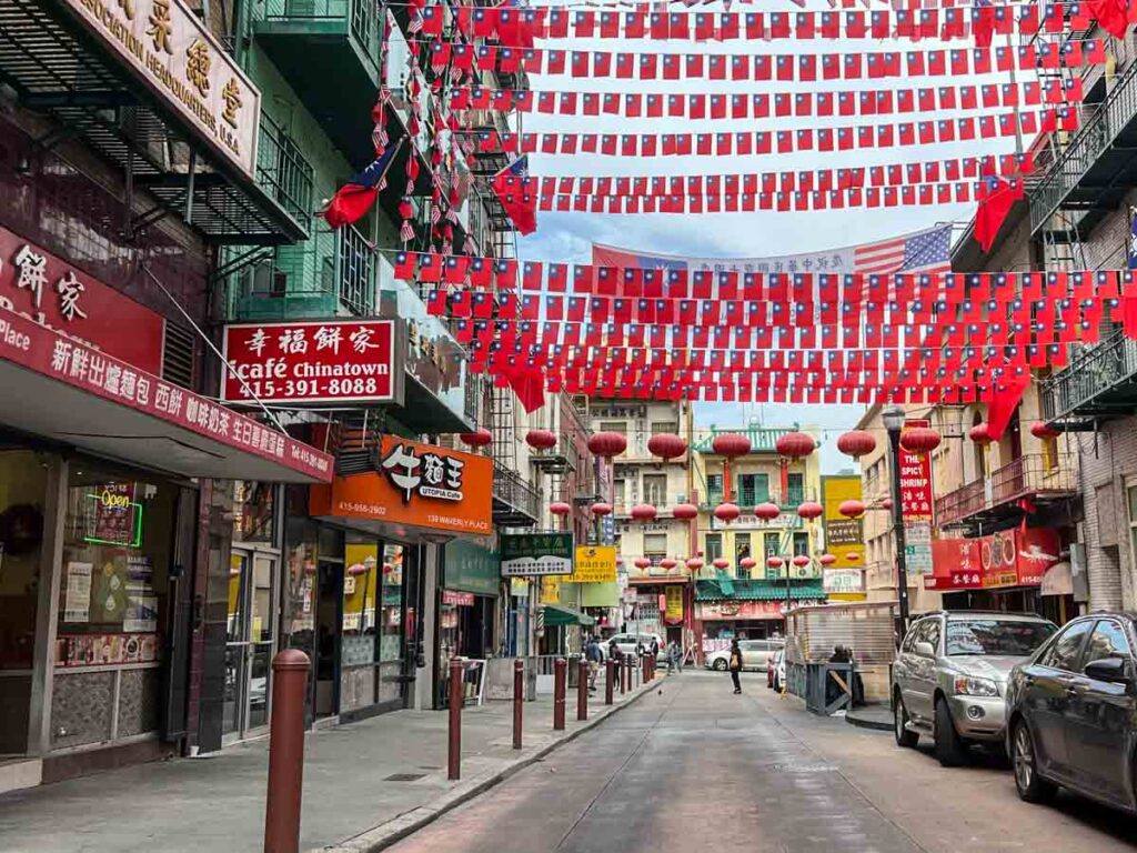 San Francisco Chinatown street scene with banners, pedestrians and restaurants.