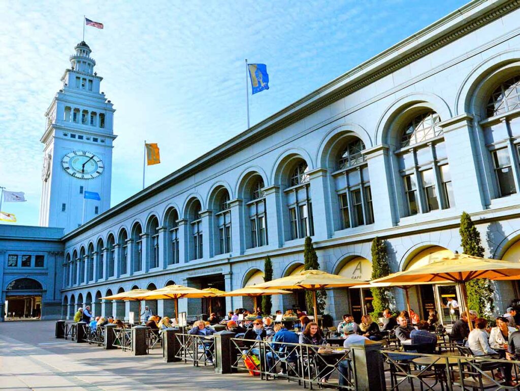 San Francisco Ferry Building exterior, with people eating outside.