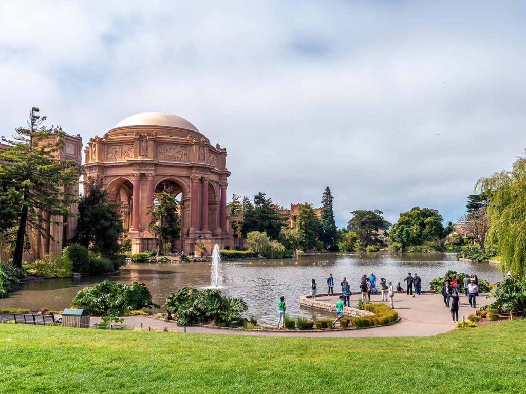 San Francisco palace of fine arts with lake and grass.