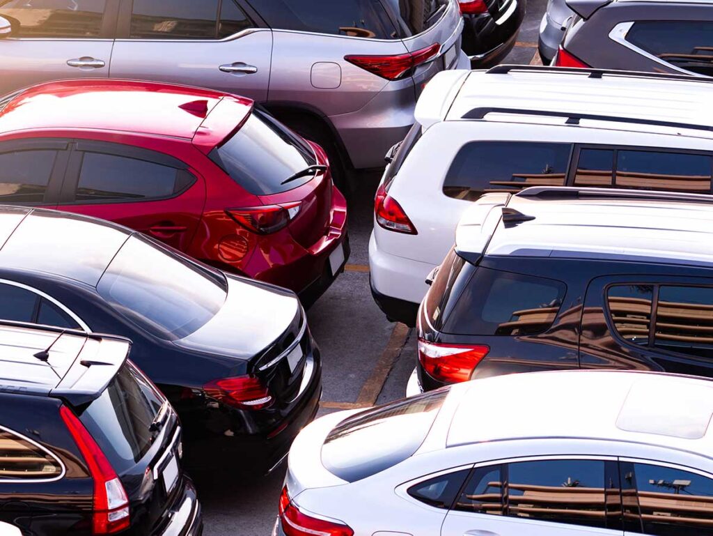 Rental Car lot with red, white and blue cars.