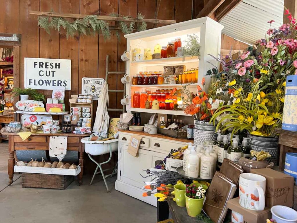 Avila Beach Barn, with flowers and honey display.