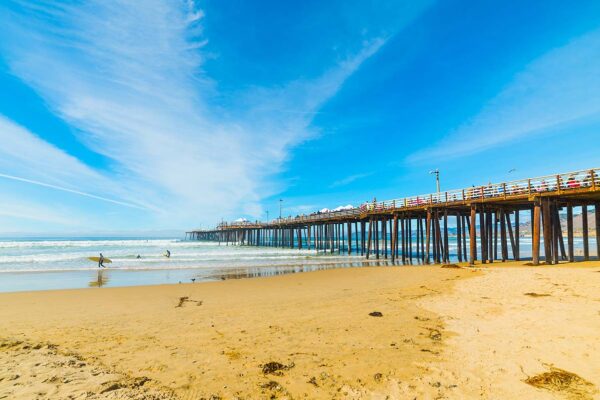 Pismo beach pier with surfers.