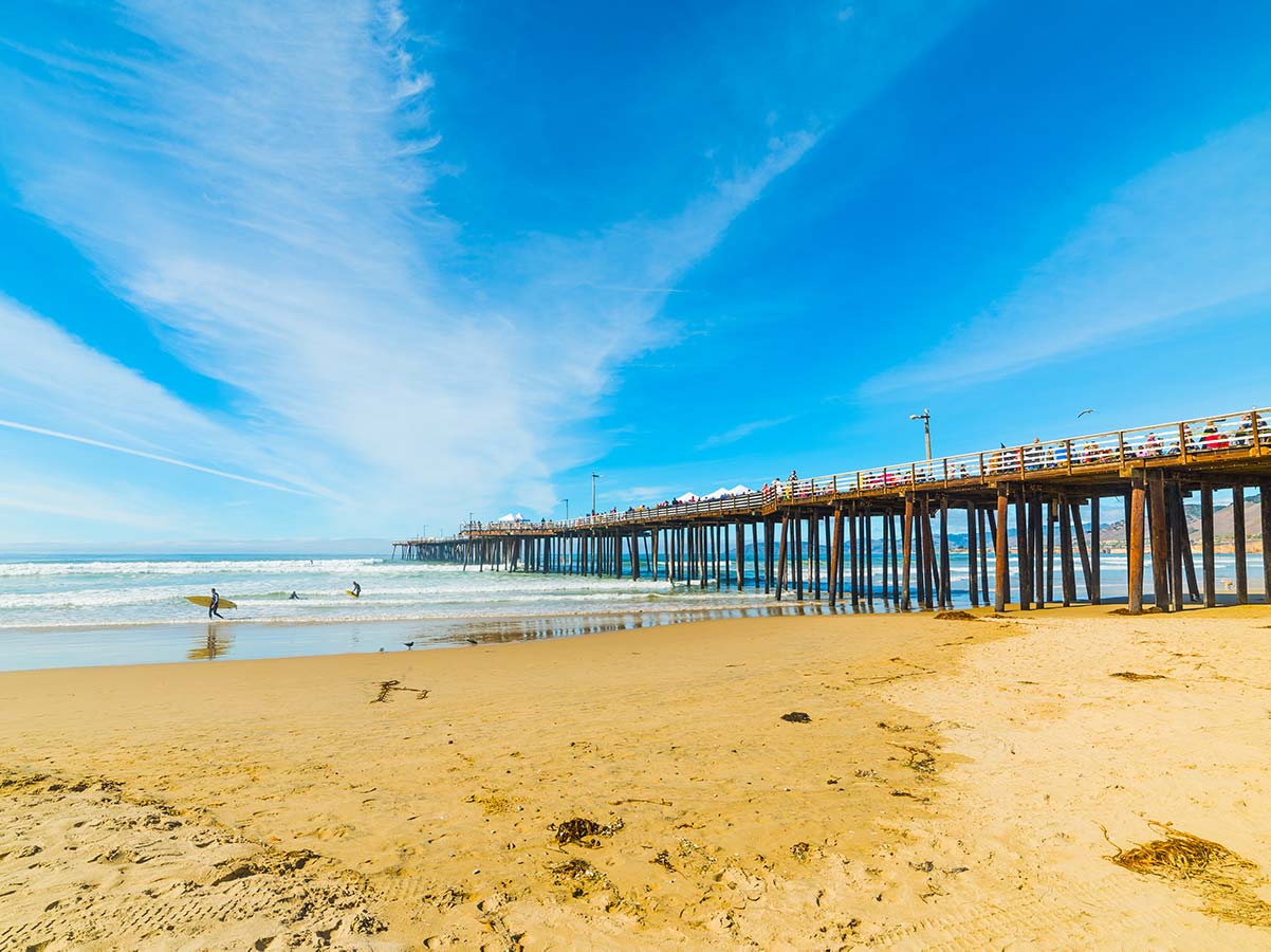 Pismo beach pier with surfers.